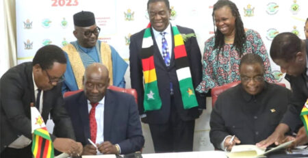 From left(Front): Dr. Bernard Madzima, CEO of NAC assisting Hon. Dr. David Pagwesese Parirenyatwa, SAA/ICASA 2023 President, with H.E. Dr. C. G.D.N. Chiwenga, Vice President and Minister of Health and Childcare/ICASA 2023 Vice President, Zimbabwe, being assisted by Air Commodore (Dr.) Jasper Chimedza, Permanent Secretary for Ministry of Health and Child Care, at the signing of the MoU at State House, Harare, Zimbabwe In the background, From left: Mr. Luc Armand Bodea, ICASA Director, H.E. Emerson Mnangagwa, President of. Zimbabwe, Prof. Morenike Ukpong, SAA Treasurer and Dr. Fikile Ndlovu, SAA Deputy Secretary General, during the Signing of the ICASA 2023 MoU, State House, Harare, Zimbabwe