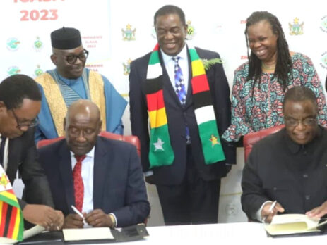From left(Front): Dr. Bernard Madzima, CEO of NAC assisting Hon. Dr. David Pagwesese Parirenyatwa, SAA/ICASA 2023 President, with H.E. Dr. C. G.D.N. Chiwenga, Vice President and Minister of Health and Childcare/ICASA 2023 Vice President, Zimbabwe, being assisted by Air Commodore (Dr.) Jasper Chimedza, Permanent Secretary for Ministry of Health and Child Care, at the signing of the MoU at State House, Harare, Zimbabwe In the background, From left: Mr. Luc Armand Bodea, ICASA Director, H.E. Emerson Mnangagwa, President of. Zimbabwe, Prof. Morenike Ukpong, SAA Treasurer and Dr. Fikile Ndlovu, SAA Deputy Secretary General, during the Signing of the ICASA 2023 MoU, State House, Harare, Zimbabwe