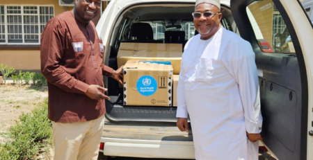 WHO-presents-toolkits-to-Mr. Innocent Laison, ICASA Onsite Manager