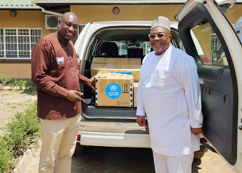 WHO-presents-toolkits-to-Mr. Innocent Laison, ICASA Onsite Manager