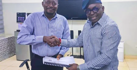 Mr. Luc Armand H. Bodea (SAA/ICASA Director) presenting ICASA 2025 audit and technical report to Dr. Fred Nana Poku (Director of Technical Services, GAC)